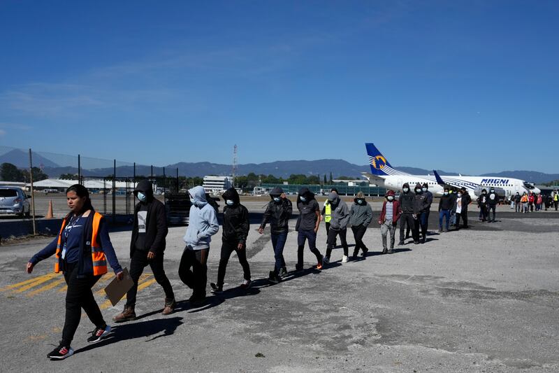 Unaccompanied Guatemalan children who were deported from Mexico deplane at La Aurora International Airport, in Guatemala City, Tuesday, Feb. 7, 2023. The children were stopped in the border between Mexico and United States. (AP Photo/Moises Castillo)