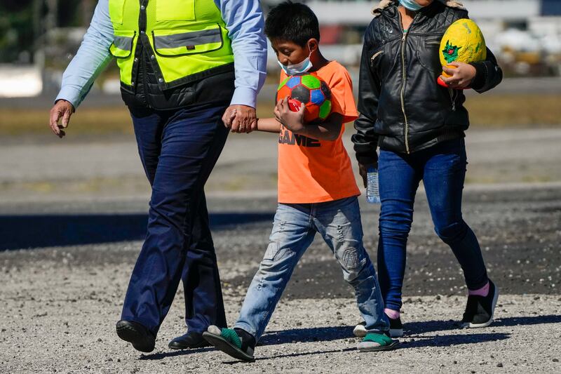 Unaccompanied Guatemalan children who were deported from Mexico deplane at La Aurora International Airport, in Guatemala City, Tuesday, Feb. 7, 2023. The children were stopped in the border between Mexico and United States. (AP Photo/Moises Castillo)