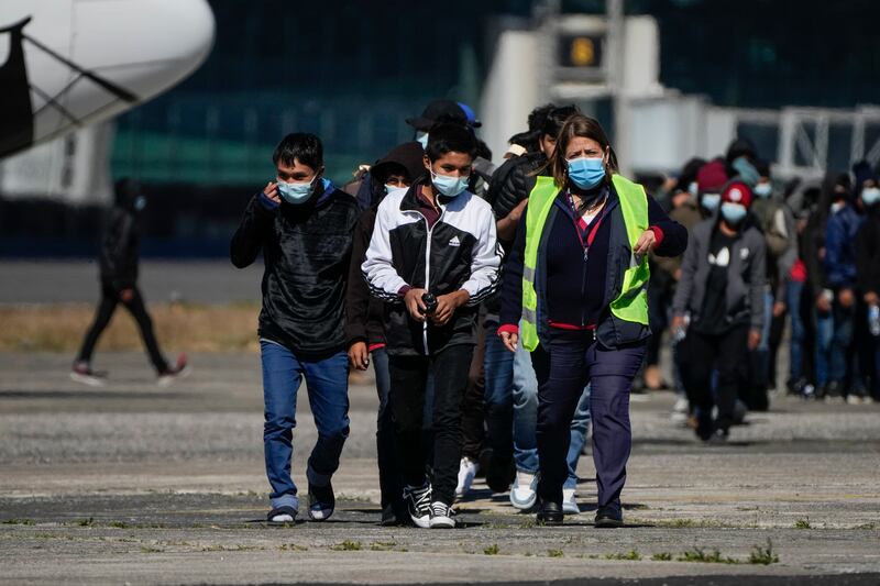 Unaccompanied Guatemalan children who were deported from Mexico deplane at La Aurora International Airport, in Guatemala City, Tuesday, Feb. 7, 2023. The children were stopped in the border between Mexico and United States. (AP Photo/Moises Castillo)
